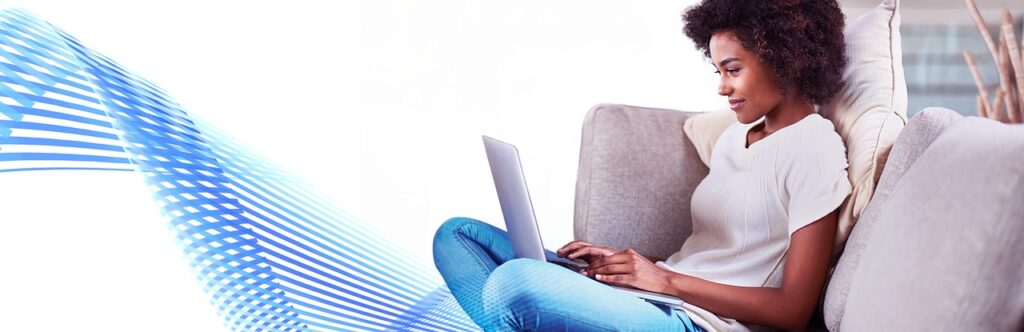 Writer typing on a laptop at a desk