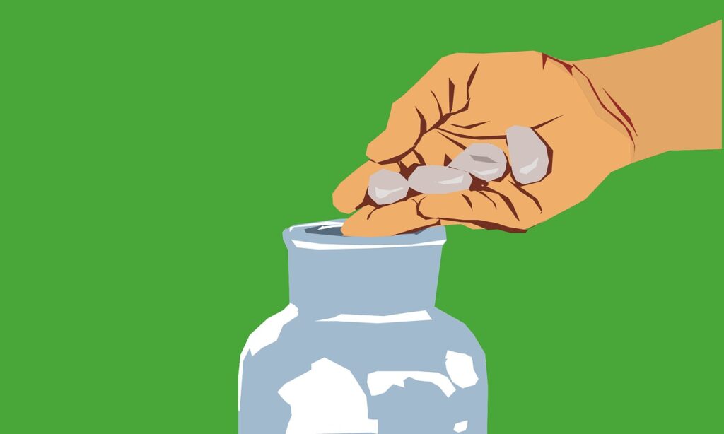 Hands holding a donation jar with coins