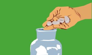 Hands holding a donation jar with coins