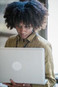Nonprofit professional evaluating donor management software on a laptop