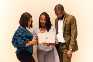 NGO program manager leading a team collaboration meeting in a Lagos office