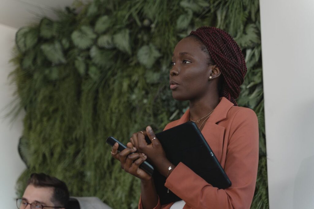 A confident nonprofit leader speaking to her team, representing first time executive director leadership skills