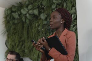 A confident nonprofit leader speaking to her team, representing first time executive director leadership skills