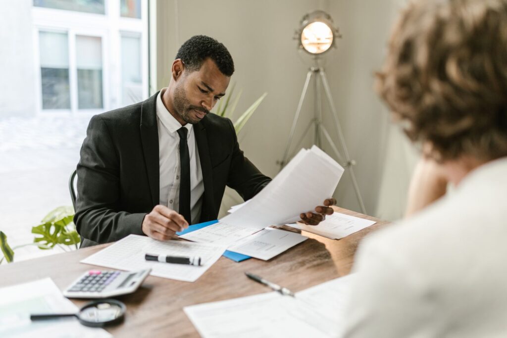 Nonprofit chief executive reviewing financial documents at his desk
