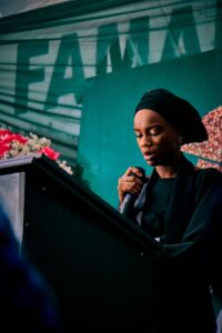 Woman speaking at a podium at a public event in Kaduna Nigeria