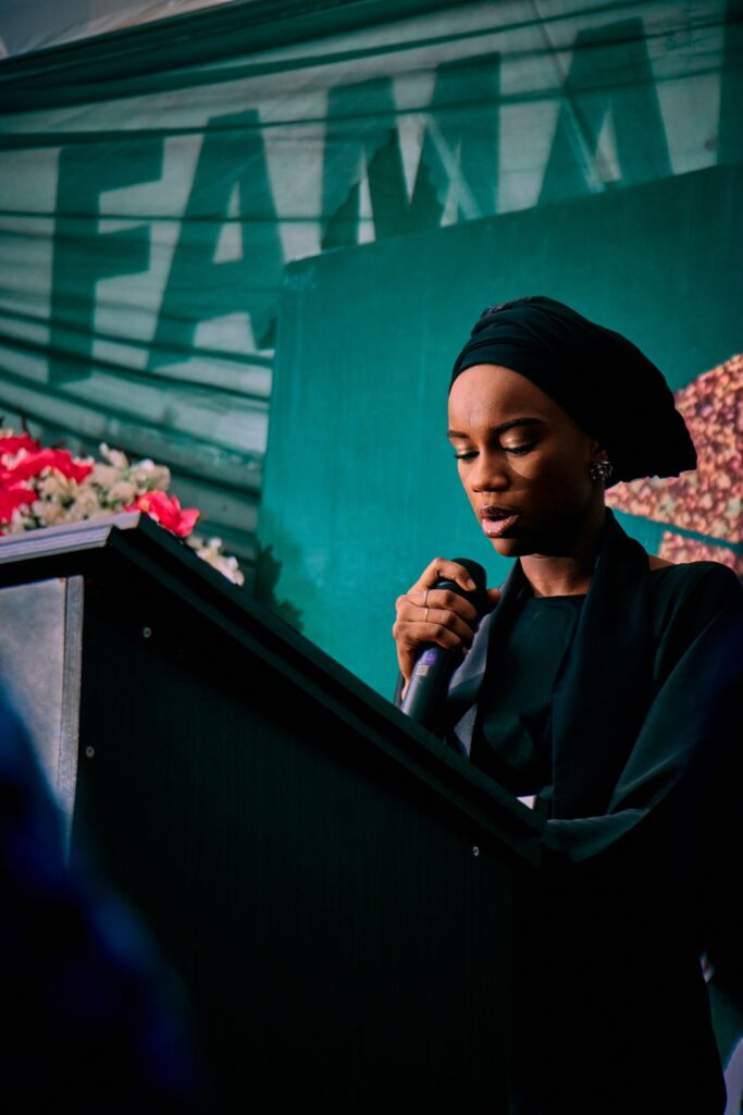 Woman speaking at a podium at a public event in Kaduna Nigeria