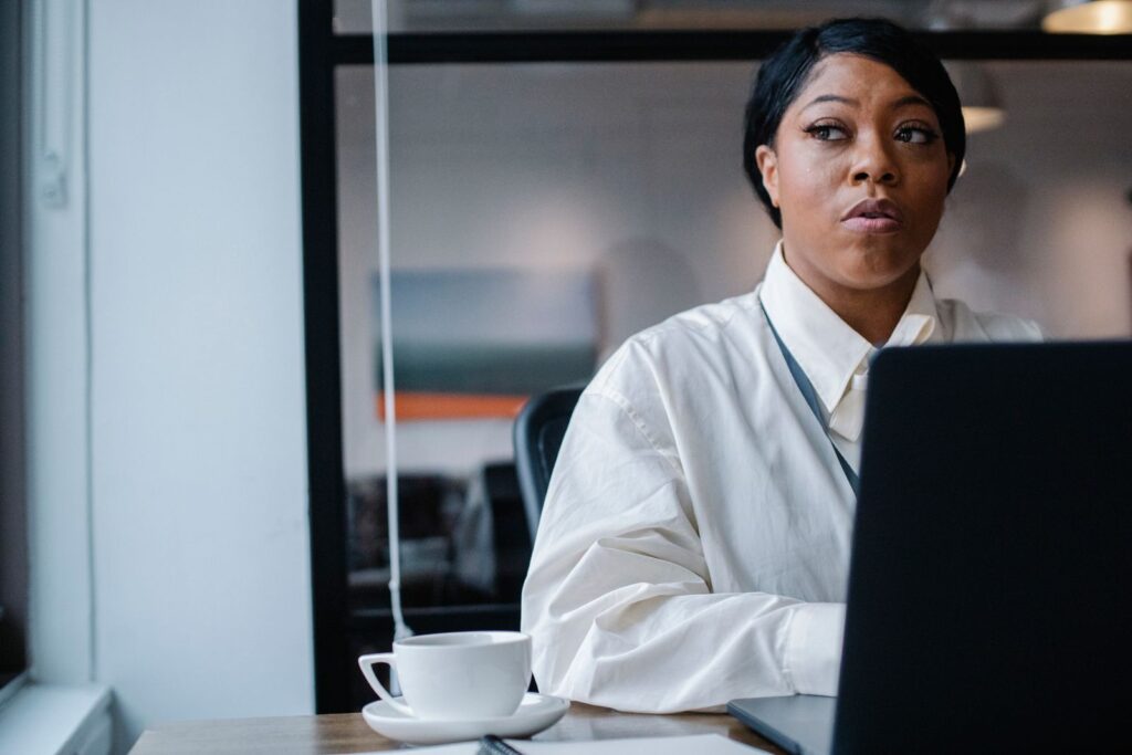 African businesswoman working on a laptop planning donor management for a nonprofit