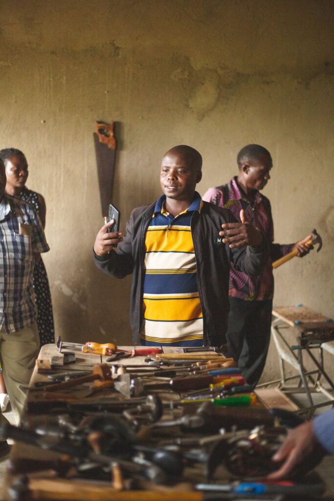 Adults engaged in a community workshop session in Uganda